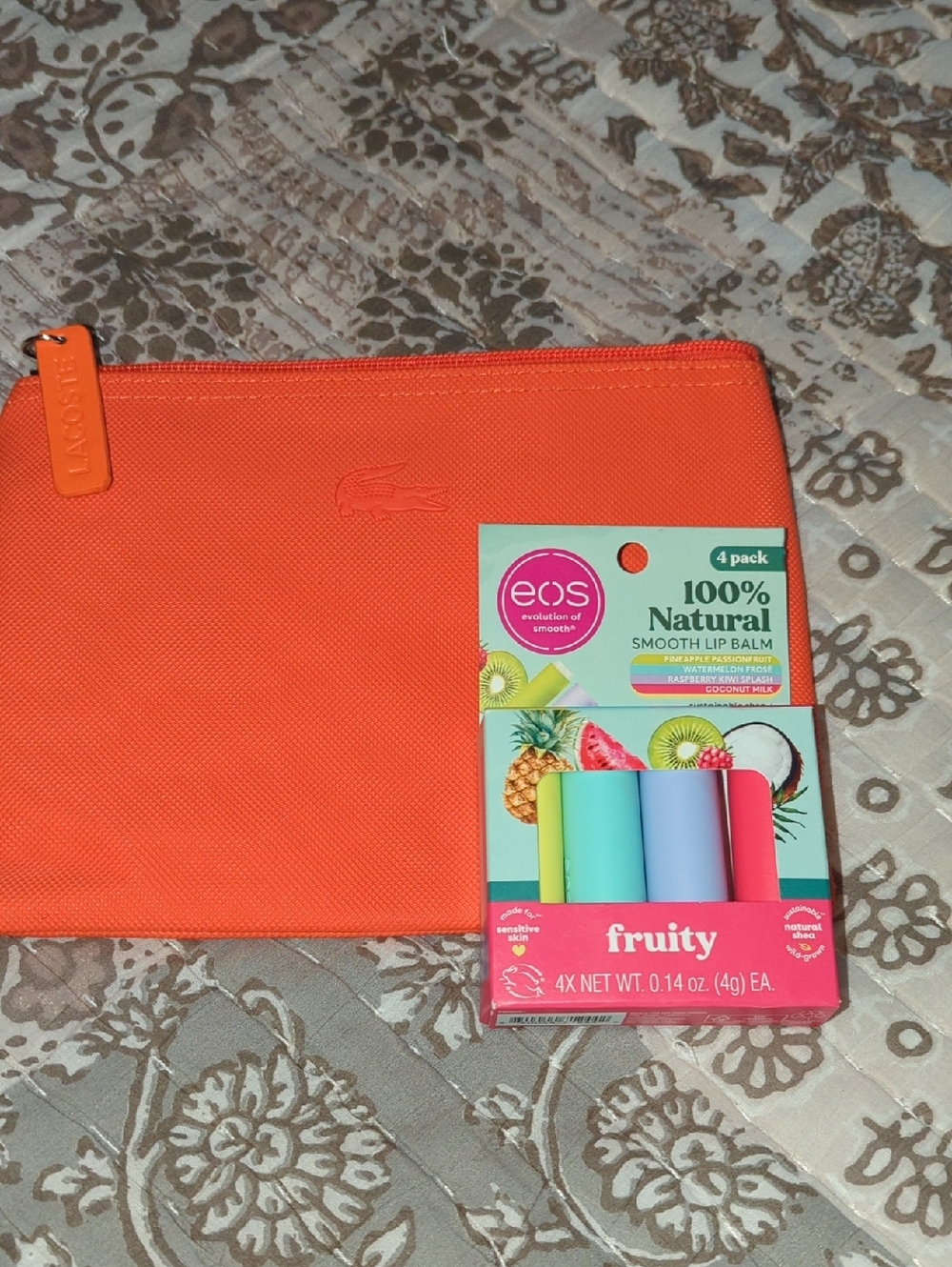 Bundle-Lacoste Orange Zip Pouch with Colorful EOS Fruity Lip Balms.